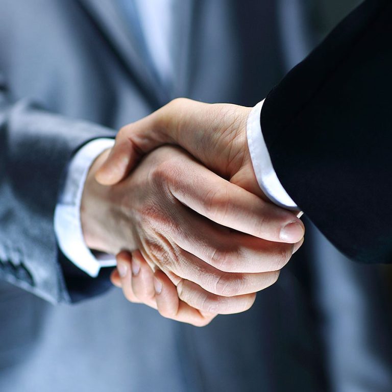 Business handshake representing trade brokerage services